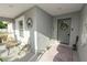 Charming front entryway with a decorative wreath, a 'Welcome' sign, and cozy seating area for guests at 3425 Sutton Ridge St, Lakeland, FL 33810