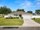 Well-maintained one-story home featuring a manicured front yard, charming porch, and an attached two-car garage at 3425 Sutton Ridge St, Lakeland, FL 33810