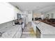 Modern kitchen with stainless appliances, granite counters, white cabinets, and an island open to the living room at 3425 Sutton Ridge St, Lakeland, FL 33810