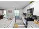 Bright kitchen features granite countertops, stainless steel appliances, and wood-look flooring at 3425 Sutton Ridge St, Lakeland, FL 33810