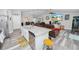 Open kitchen design with granite counters, stainless appliances, white cabinetry, and seamless flow to the living area at 3425 Sutton Ridge St, Lakeland, FL 33810
