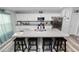 Bright kitchen boasts white cabinets, granite countertops, stainless appliances, and a convenient island with seating at 3425 Sutton Ridge St, Lakeland, FL 33810