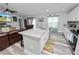 Open kitchen with island bar overlooking the living area, with stainless steel appliances at 3425 Sutton Ridge St, Lakeland, FL 33810