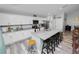 Well-lit kitchen with white cabinetry, granite countertops, stainless steel appliances, and island seating at 3425 Sutton Ridge St, Lakeland, FL 33810