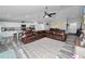 Expansive living space with wood-look flooring, a leather sectional, and views into the kitchen and dining area at 3425 Sutton Ridge St, Lakeland, FL 33810