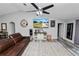 Comfortable living room featuring wood-look floors, a mounted television, and access to other areas of the house at 3425 Sutton Ridge St, Lakeland, FL 33810