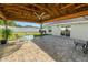 Covered patio area featuring pavers, a ceiling fan, and outdoor dining furniture, perfect for entertaining guests at 3425 Sutton Ridge St, Lakeland, FL 33810