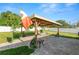 Covered patio with ample seating, a dining table, and string lights, perfect for outdoor gatherings in the backyard at 3425 Sutton Ridge St, Lakeland, FL 33810