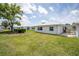 The backyard features green grass, a patio and a clean white exterior at 3570 Milano Ave # 3570, Lakeland, FL 33803