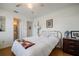 Comfortable bedroom with hardwood floors, a brass bed frame, ceiling fan, and easy access to the bathroom at 3570 Milano Ave # 3570, Lakeland, FL 33803