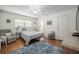 The bright bedroom features hardwood floors, a ceiling fan, and natural light from a window at 3570 Milano Ave # 3570, Lakeland, FL 33803