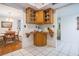 Butler's pantry between kitchen and dining, featuring wood cabinets, granite countertops, and neutral tile at 3570 Milano Ave # 3570, Lakeland, FL 33803
