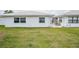 Rear exterior showing well manicured lawn, patio, and white siding, perfect for outdoor living at 3570 Milano Ave # 3570, Lakeland, FL 33803
