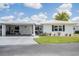 Well-maintained single-story home with a covered carport and lush green lawn at 3570 Milano Ave # 3570, Lakeland, FL 33803