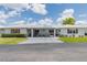 Charming home with a pristine white exterior, covered carport, and well-manicured lawn at 3570 Milano Ave # 3570, Lakeland, FL 33803