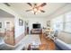 The living room features hardwood floors, a ceiling fan, and natural light from a window at 3570 Milano Ave # 3570, Lakeland, FL 33803