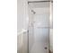 The bright and white shower has a tiled floor and walls with a handheld shower head at 3570 Milano Ave # 3570, Lakeland, FL 33803