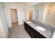 Bathroom features a double granite vanity and tile floors and adjacent closets at 3882 Resting Robin Ave, Bartow, FL 33830