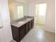 Bathroom features a double granite vanity and tile floors at 3882 Resting Robin Ave, Bartow, FL 33830