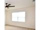 Bedroom with a large window, ceiling fan, and neutral carpeting at 3882 Resting Robin Ave, Bartow, FL 33830
