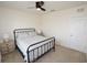 Bedroom showcasing an iron bed frame, neutral walls, and carpet at 3882 Resting Robin Ave, Bartow, FL 33830