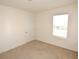 Bright bedroom featuring neutral carpet, a window, and a closet door at 3882 Resting Robin Ave, Bartow, FL 33830