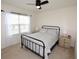 Bedroom featuring an iron bed frame, carpet, a ceiling fan and bedside tables at 3882 Resting Robin Ave, Bartow, FL 33830