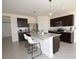 Contemporary kitchen featuring a granite island with bar seating and stainless steel appliances at 3882 Resting Robin Ave, Bartow, FL 33830