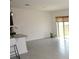 Bright kitchen featuring gray tile flooring, a breakfast bar, and modern lighting at 3882 Resting Robin Ave, Bartow, FL 33830