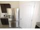 Kitchen with stainless steel refrigerator and dark cabinetry for a sleek look at 3882 Resting Robin Ave, Bartow, FL 33830
