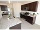 Elegant kitchen boasting dark cabinetry, stainless appliances, and a granite countertop at 3882 Resting Robin Ave, Bartow, FL 33830