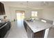 Bright kitchen with a center island, stainless steel appliances, and sliding glass doors at 3882 Resting Robin Ave, Bartow, FL 33830