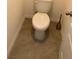 Bathroom featuring toilet with neutral wall paint and grey floor tile at 3882 Resting Robin Ave, Bartow, FL 33830