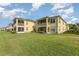 Home exterior with a large backyard, screened lanais, and lush green grass at 3923 Serenade Ln # 426, Lakeland, FL 33811