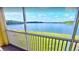 A serene balcony view showcases a tranquil lake surrounded by lush greenery and a vibrant blue sky at 3923 Serenade Ln # 426, Lakeland, FL 33811