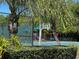 Community basketball court and playground are surrounded by lush trees and well-maintained landscaping at 3923 Serenade Ln # 426, Lakeland, FL 33811