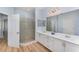 Bright bathroom featuring a glass shower, double vanity sink, and modern fixtures at 3923 Serenade Ln # 426, Lakeland, FL 33811