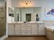 Modern bathroom featuring double vanity, walk-in shower, and a soaking tub at 3923 Serenade Ln # 426, Lakeland, FL 33811