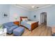 Light-filled bedroom with wood furnishings, sitting chair, and bright blue walls at 3923 Serenade Ln # 426, Lakeland, FL 33811