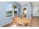 Cozy breakfast nook features a wood table, views of the lake, and light blue painted walls at 3923 Serenade Ln # 426, Lakeland, FL 33811