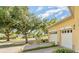 Two-car garage in a well-maintained home featuring a brick driveway and manicured landscaping at 3923 Serenade Ln # 426, Lakeland, FL 33811