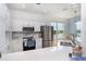 Open kitchen featuring marble backsplash, stainless steel appliances, and eat-in counter at 3923 Serenade Ln # 426, Lakeland, FL 33811
