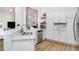 Bright kitchen with stainless steel appliances, white cabinetry and light wood flooring at 3923 Serenade Ln # 426, Lakeland, FL 33811