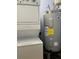 Functional laundry area with stacked washer and dryer, and a water heater at 3923 Serenade Ln # 426, Lakeland, FL 33811
