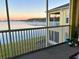 Enjoy the morning sunrise from this screened patio with serene lake views and comfortable seating at 3923 Serenade Ln # 426, Lakeland, FL 33811