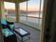 Enjoy the morning sunrise from this screened patio with comfortable seating and serene lake views at 3923 Serenade Ln # 426, Lakeland, FL 33811