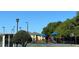 Playground, basketball court, and well-maintained field with a clear blue sky backdrop at 3923 Serenade Ln # 426, Lakeland, FL 33811