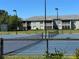 Community tennis court features well-maintained landscaping, and nearby residential buildings at 3923 Serenade Ln # 426, Lakeland, FL 33811