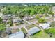 An aerial view of the home, nestled in a neighborhood with mature trees and well-maintained streets at 407 Ne 8Th St, Mulberry, FL 33860