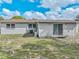 Backyard of home features siding, grassy areas, a sliding glass door and privacy at 407 Ne 8Th St, Mulberry, FL 33860